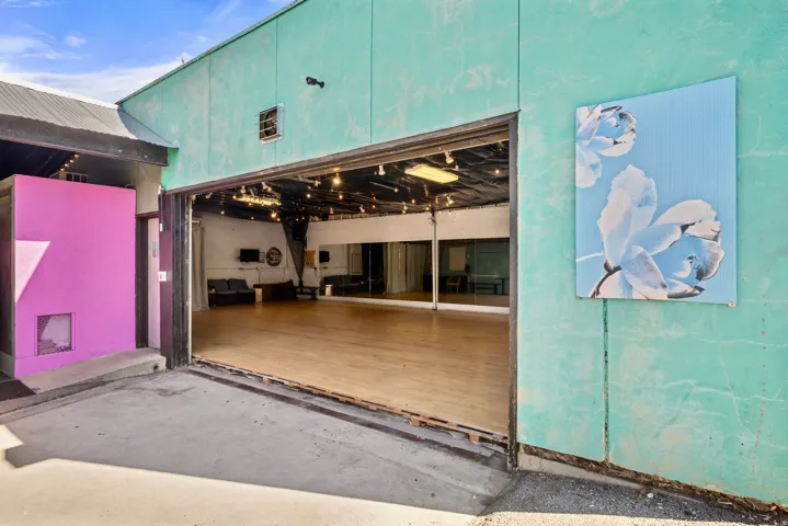Doorway to property featuring a garage and a patio