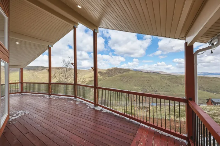 Deck with a mountain view and a view of rural / pastoral area