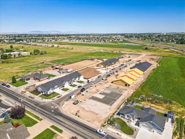 Aerial view of property and surrounding area with nearby suburban area and a large body of water