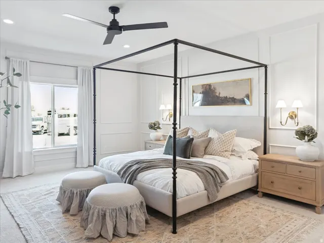 Carpeted bedroom with ceiling fan, recessed lighting, and a decorative wall