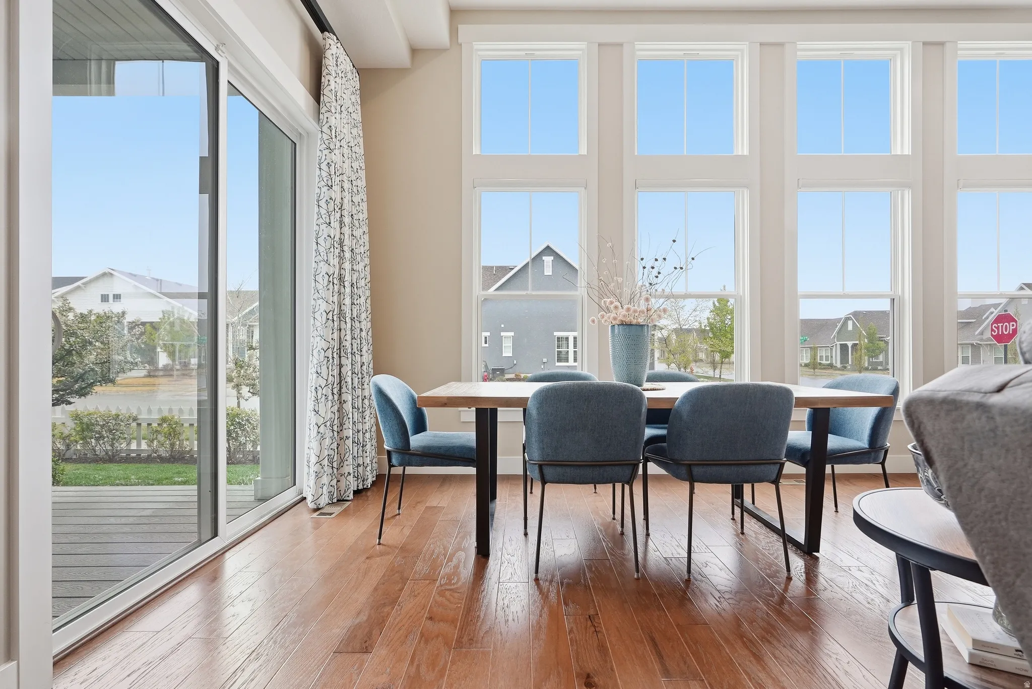 Dining area featuring plenty of natural light, wood-type flooring, and a residential view
