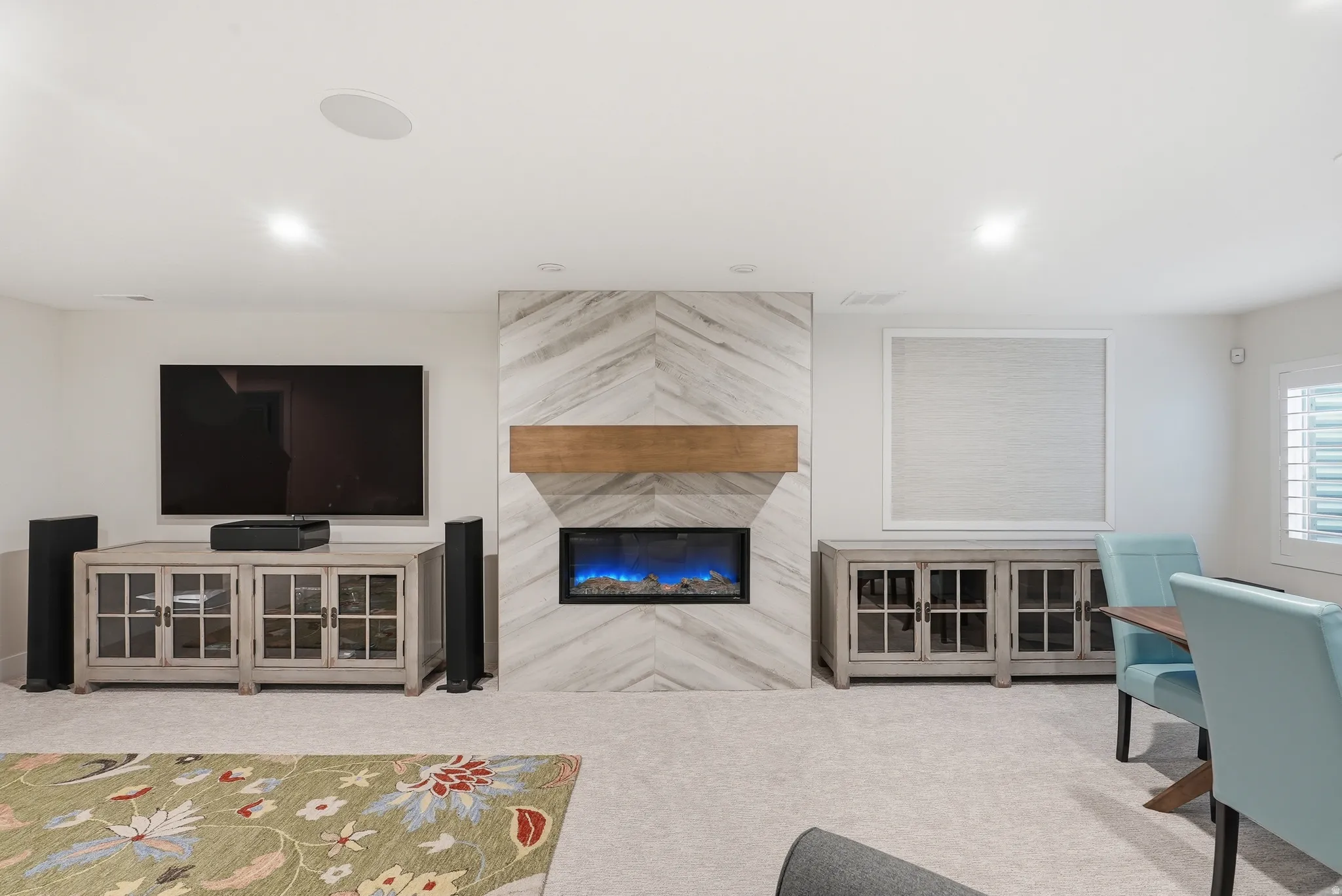Living area featuring light colored carpet and a premium fireplace