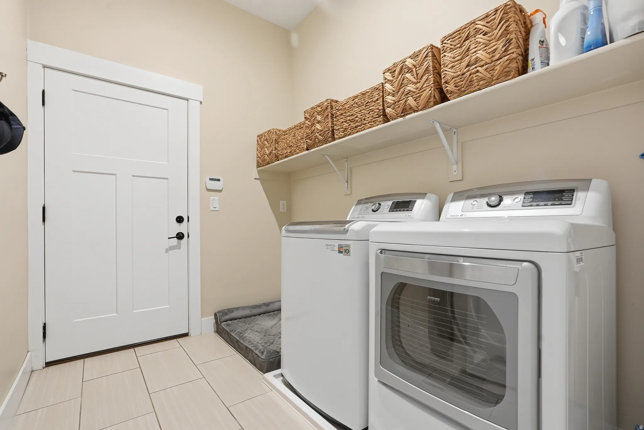 Laundry room with separate washer and dryer and baseboards