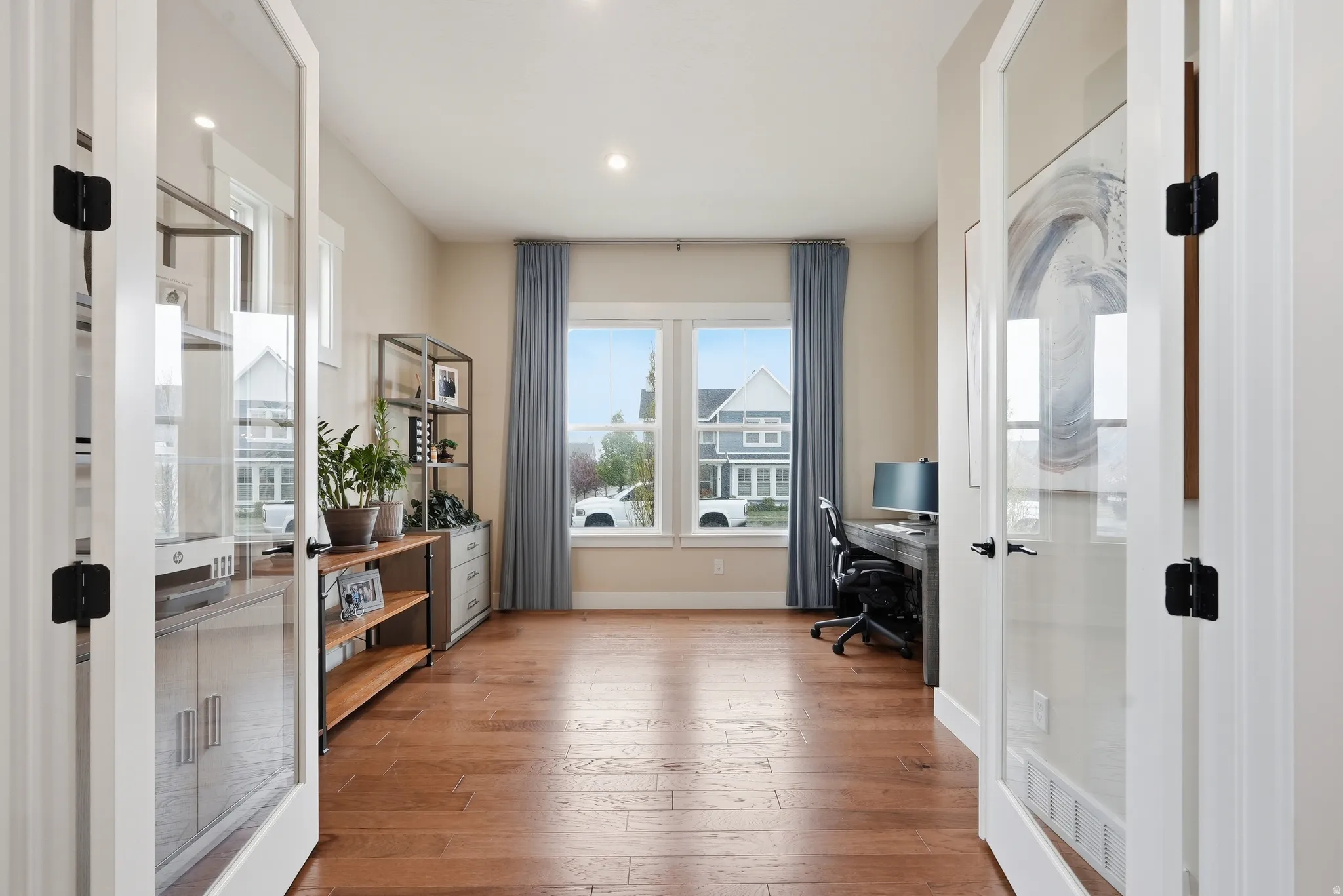 Office area featuring light wood finished floors, recessed lighting, and french doors