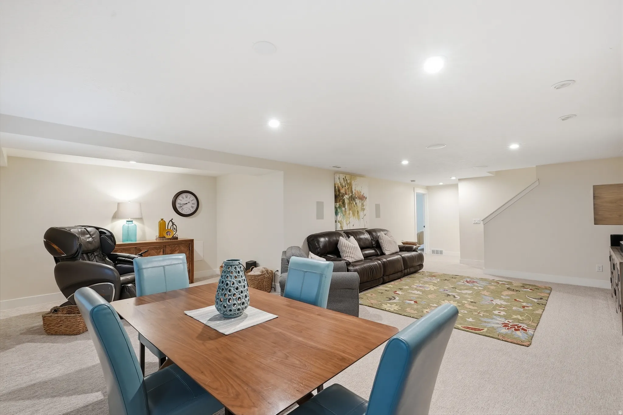 Dining room featuring light colored carpet and recessed lighting