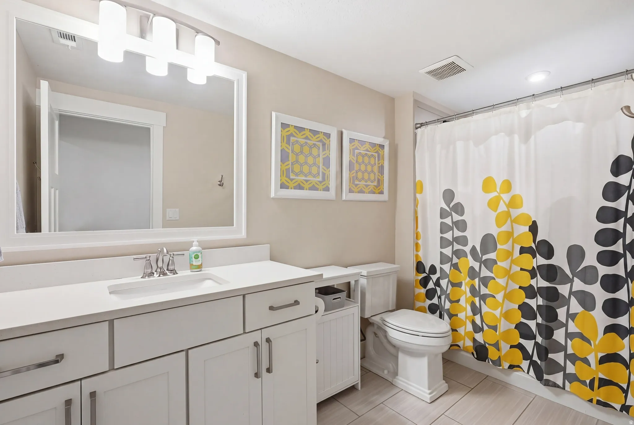 Bathroom with vanity and curtained shower