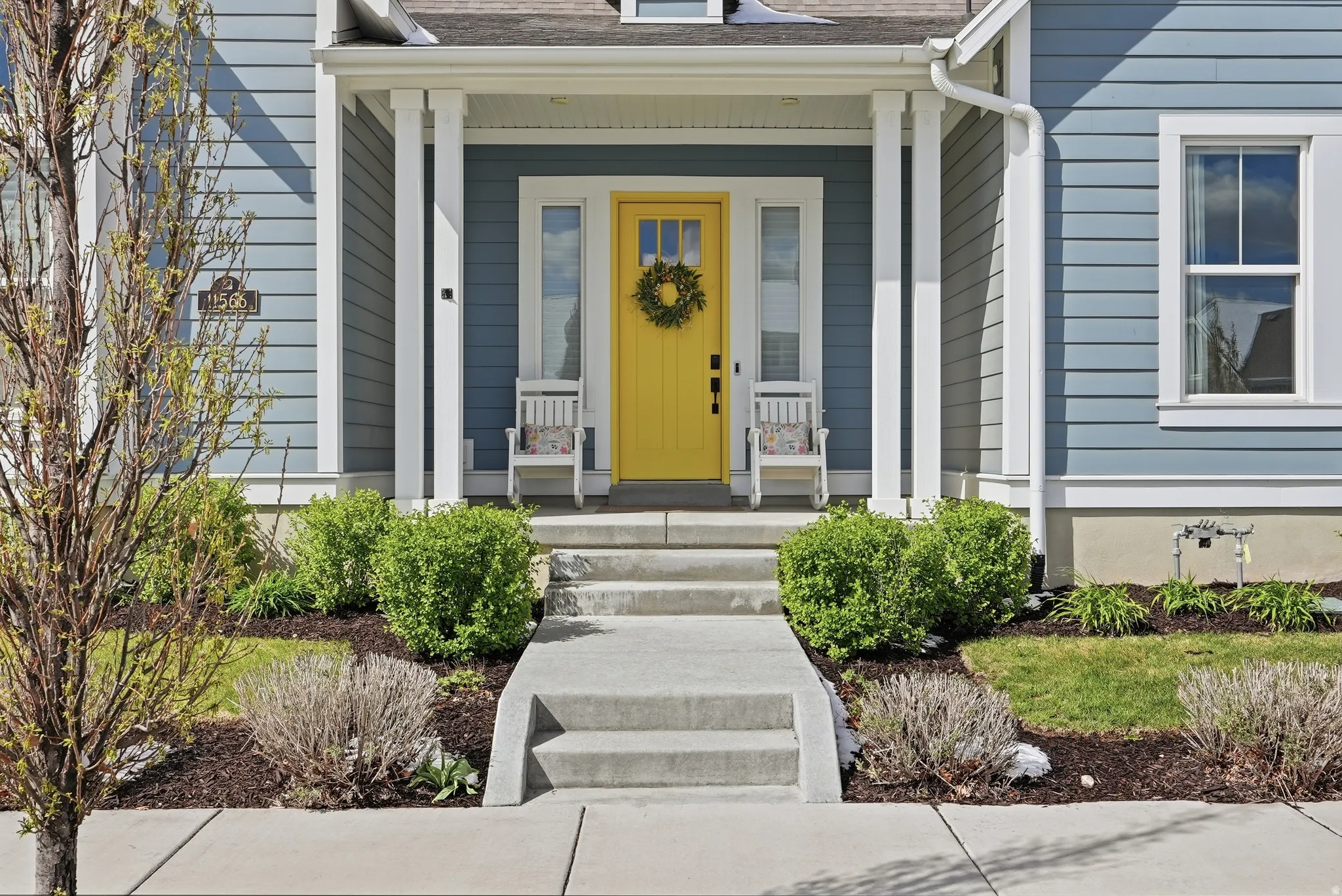 Entrance to property with a porch and roof with shingles