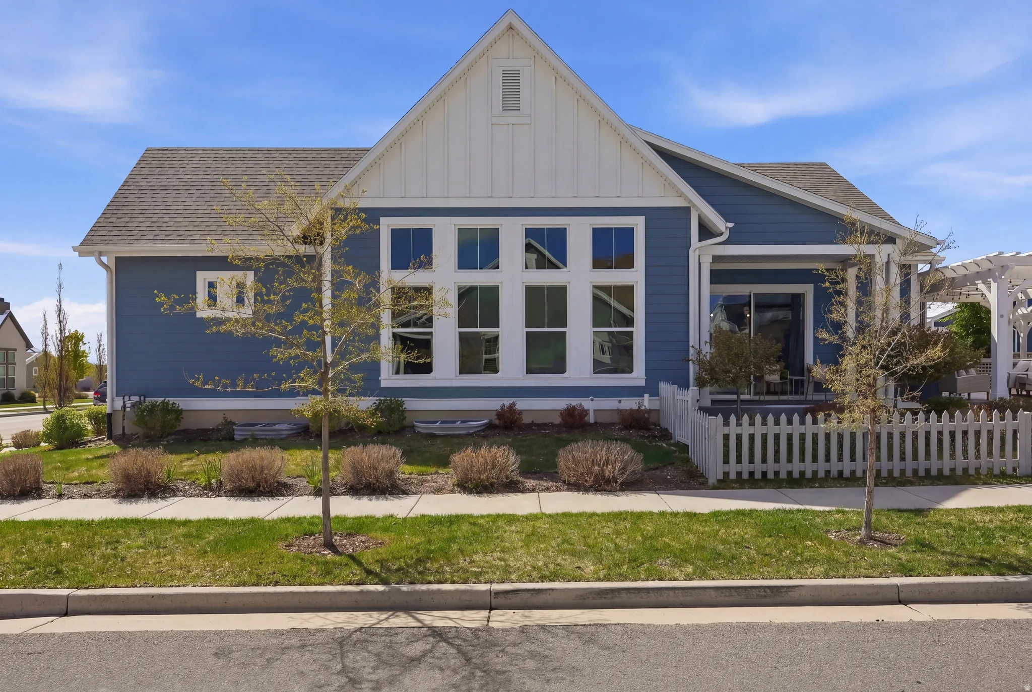 View of front of house with board and batten siding and roof with shingles