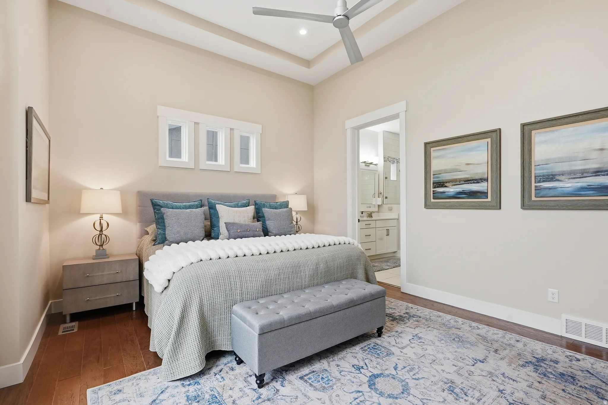 Bedroom featuring hardwood / wood-style floors, connected bathroom, and a ceiling fan