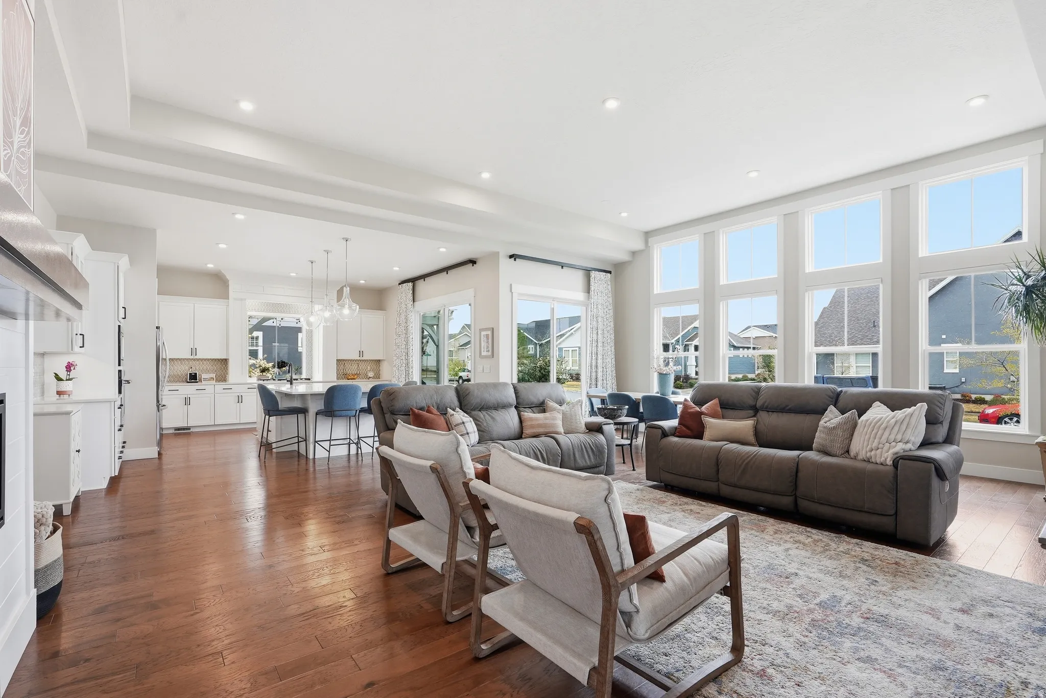 Living room featuring dark wood-style flooring and a chandelier
