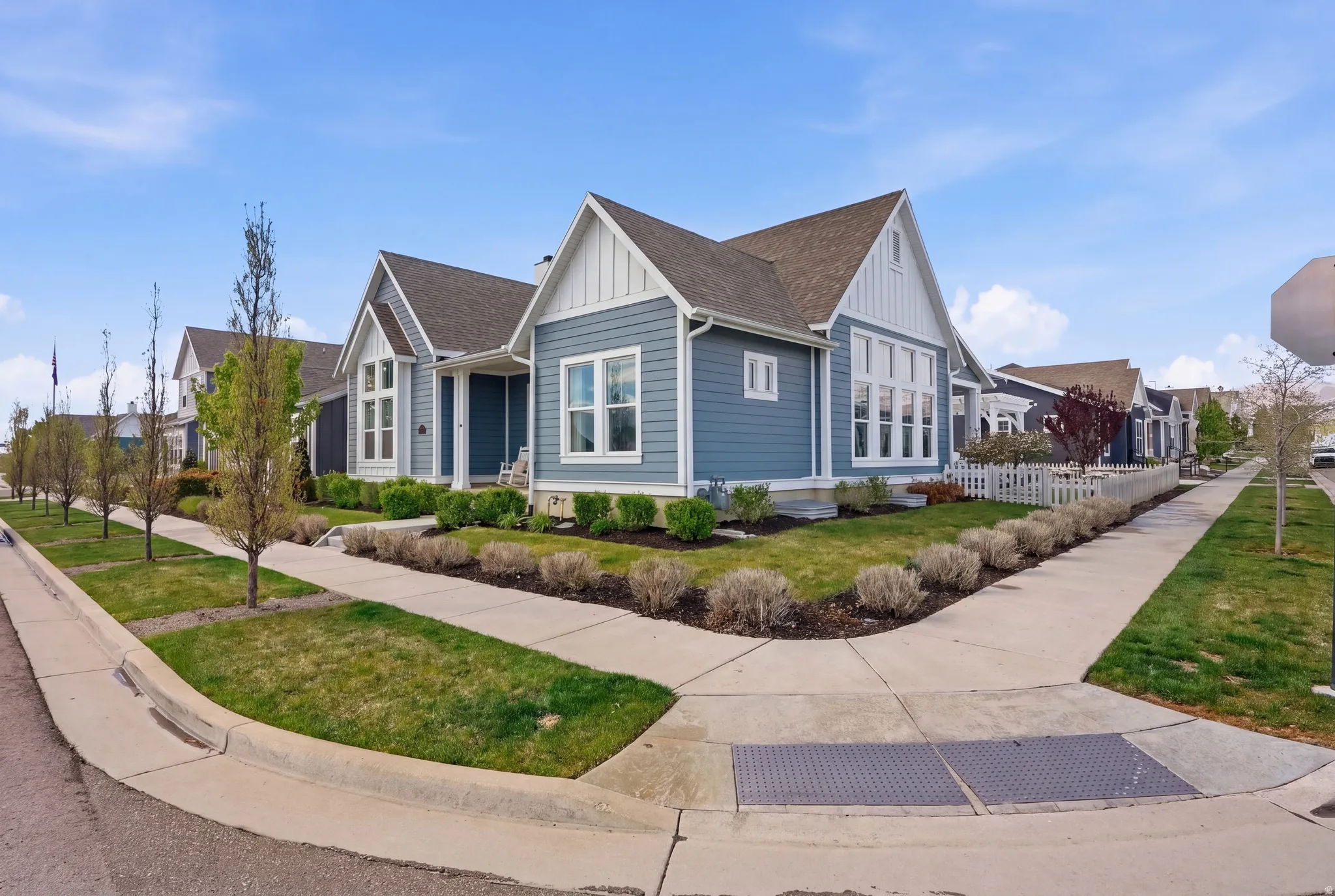 View of property exterior featuring board and batten siding, roof with shingles, and a residential view