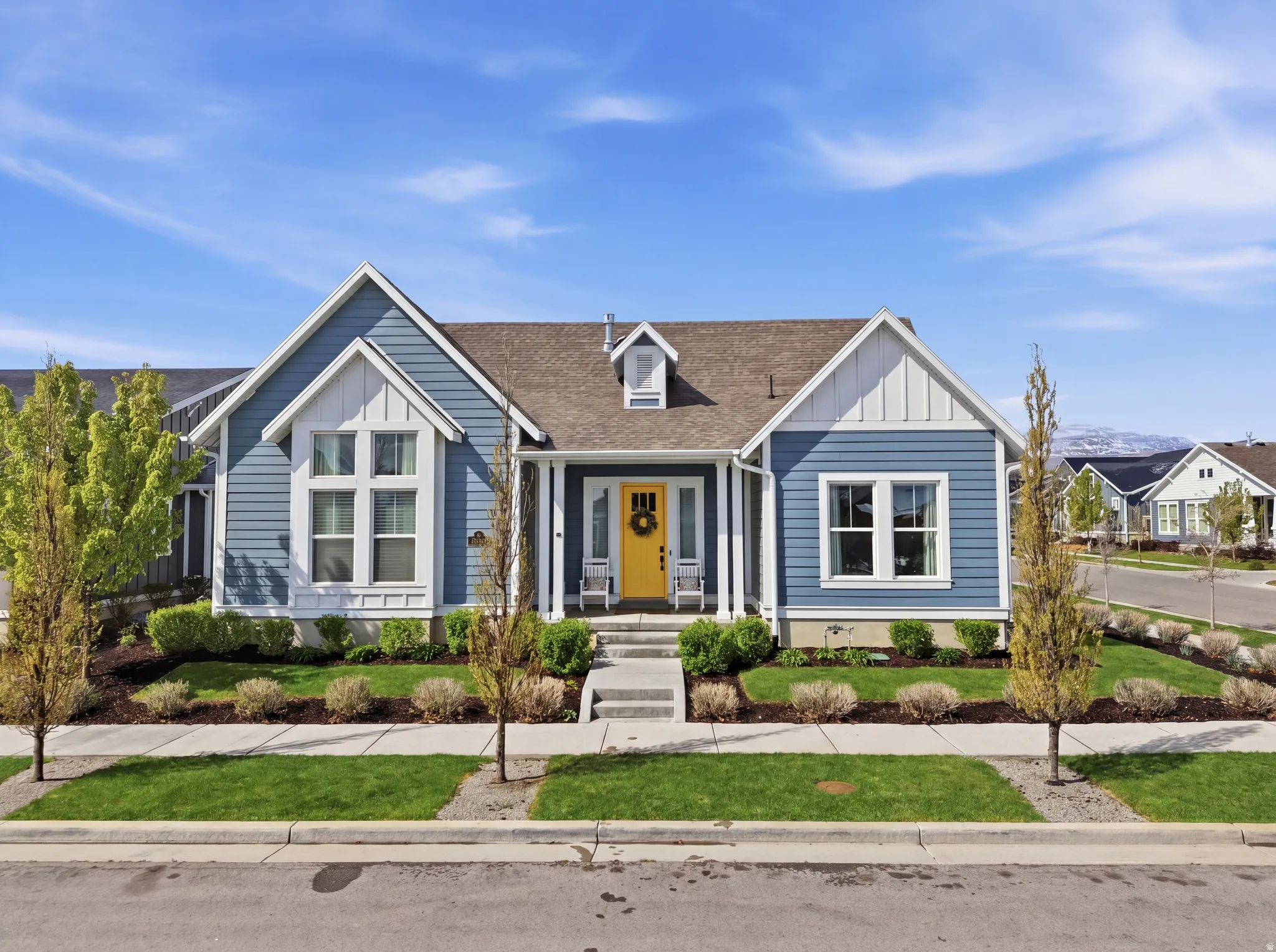 View of front of home with roof with shingles, board and batten siding, and covered porch