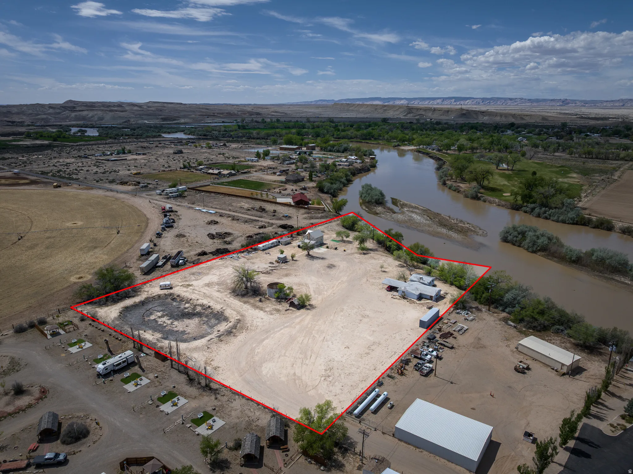 Aerial overview of property's location with property parcel outlined and a mountain backdrop