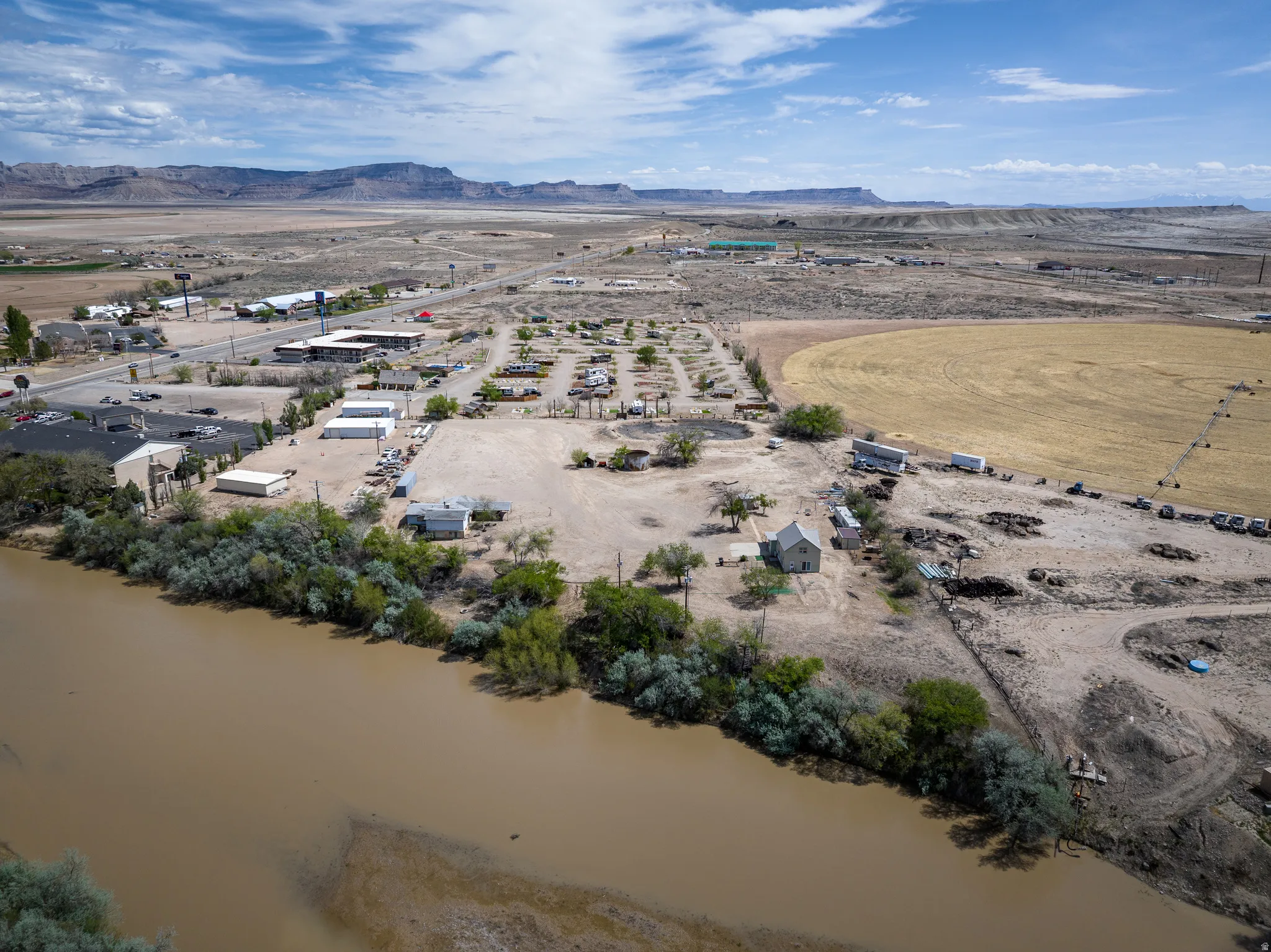 Aerial view of sparsely populated area with a water and mountain view and a desert landscape