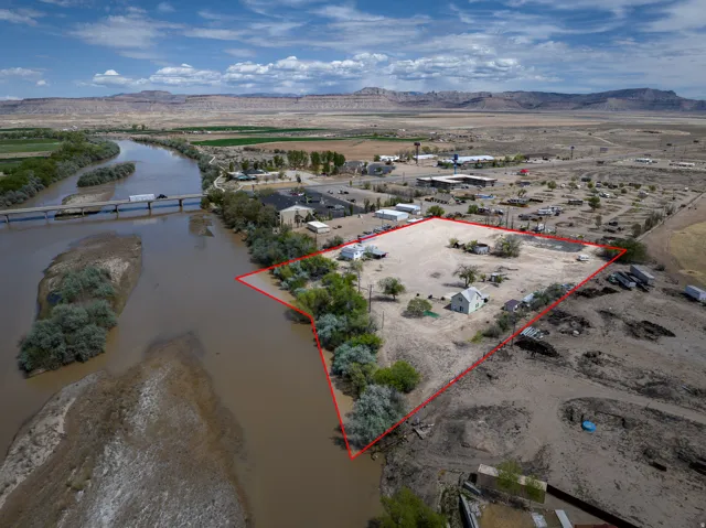 Aerial overview of property's location with a mountainous background and property parcel outlined