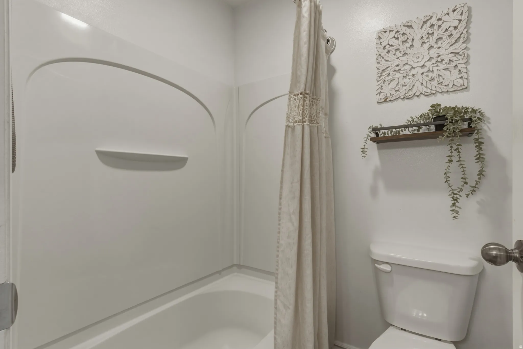 Full bath featuring toilet and shower / tub combo