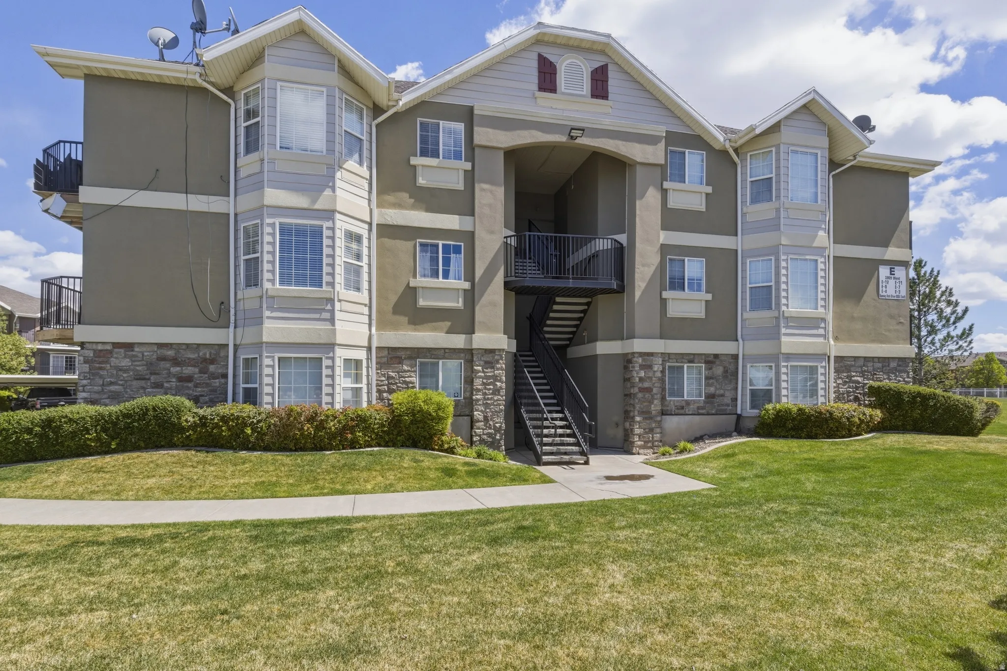 View of apartment building / complex featuring stairs