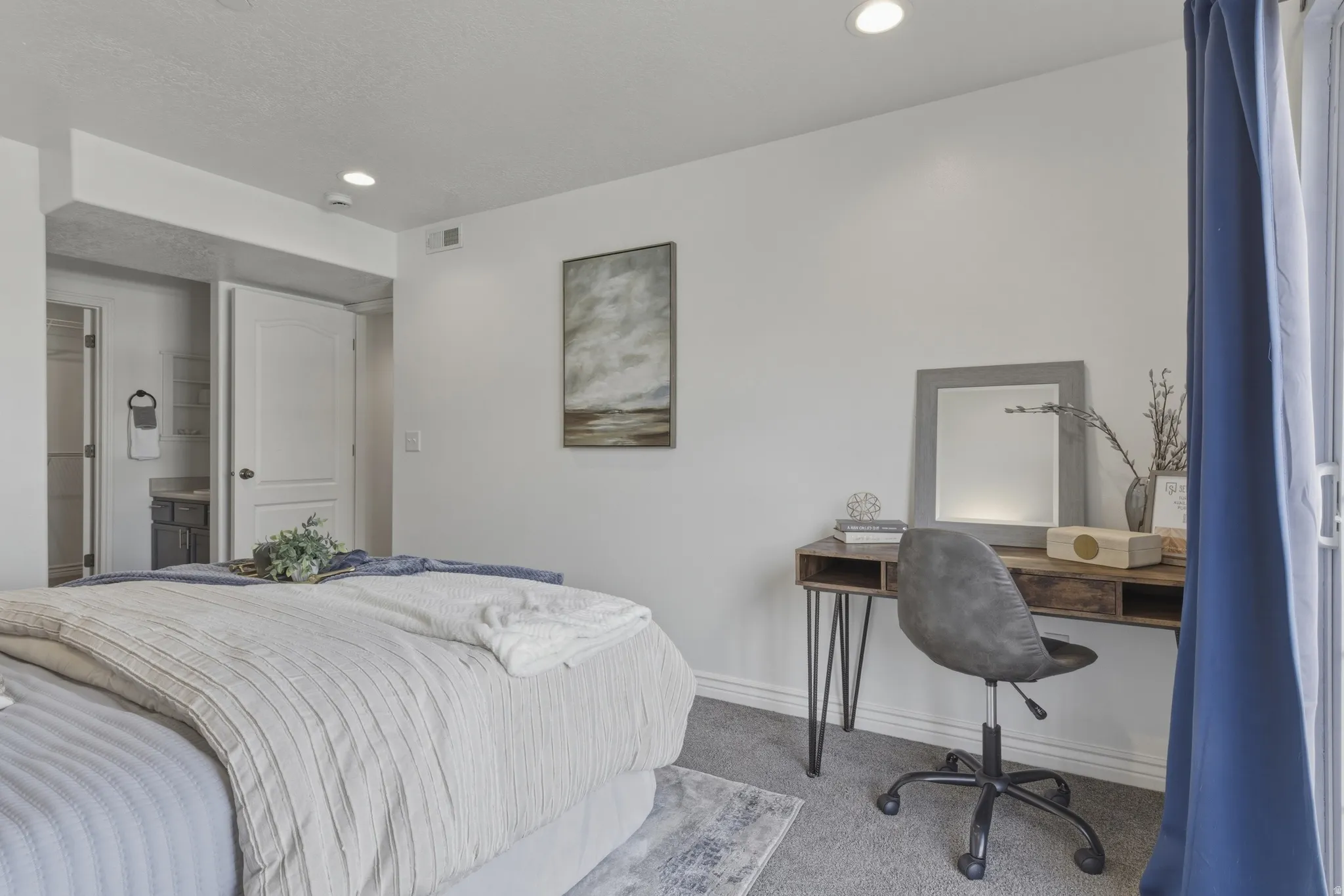 Carpeted bedroom with recessed lighting, connected bathroom, and an office area