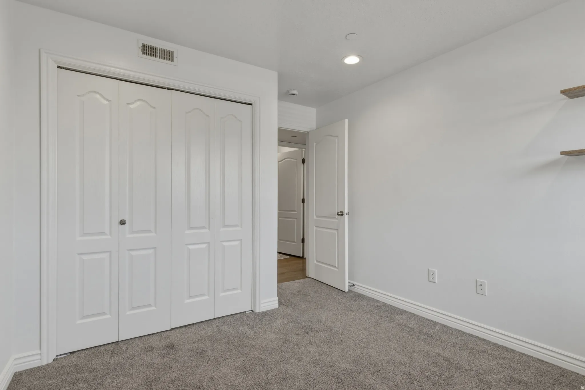 Unfurnished bedroom featuring a closet, carpet flooring, and recessed lighting