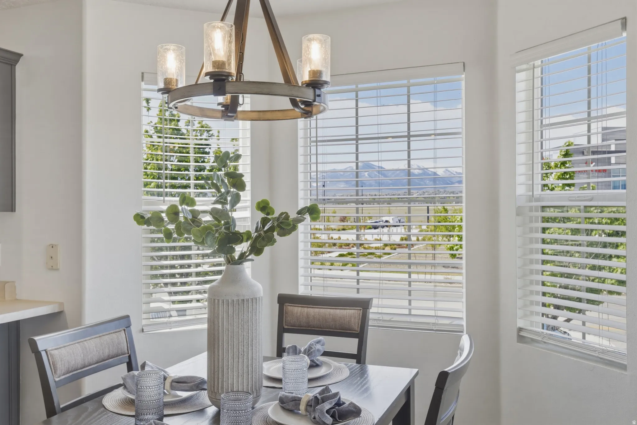 Dining space featuring a mountain view, healthy amount of natural light, and suspended lighting