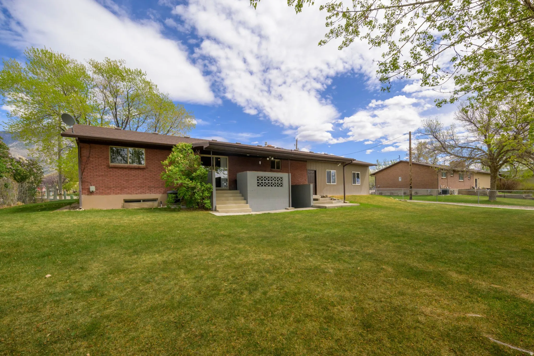 Back of house featuring a patio area and brick siding
