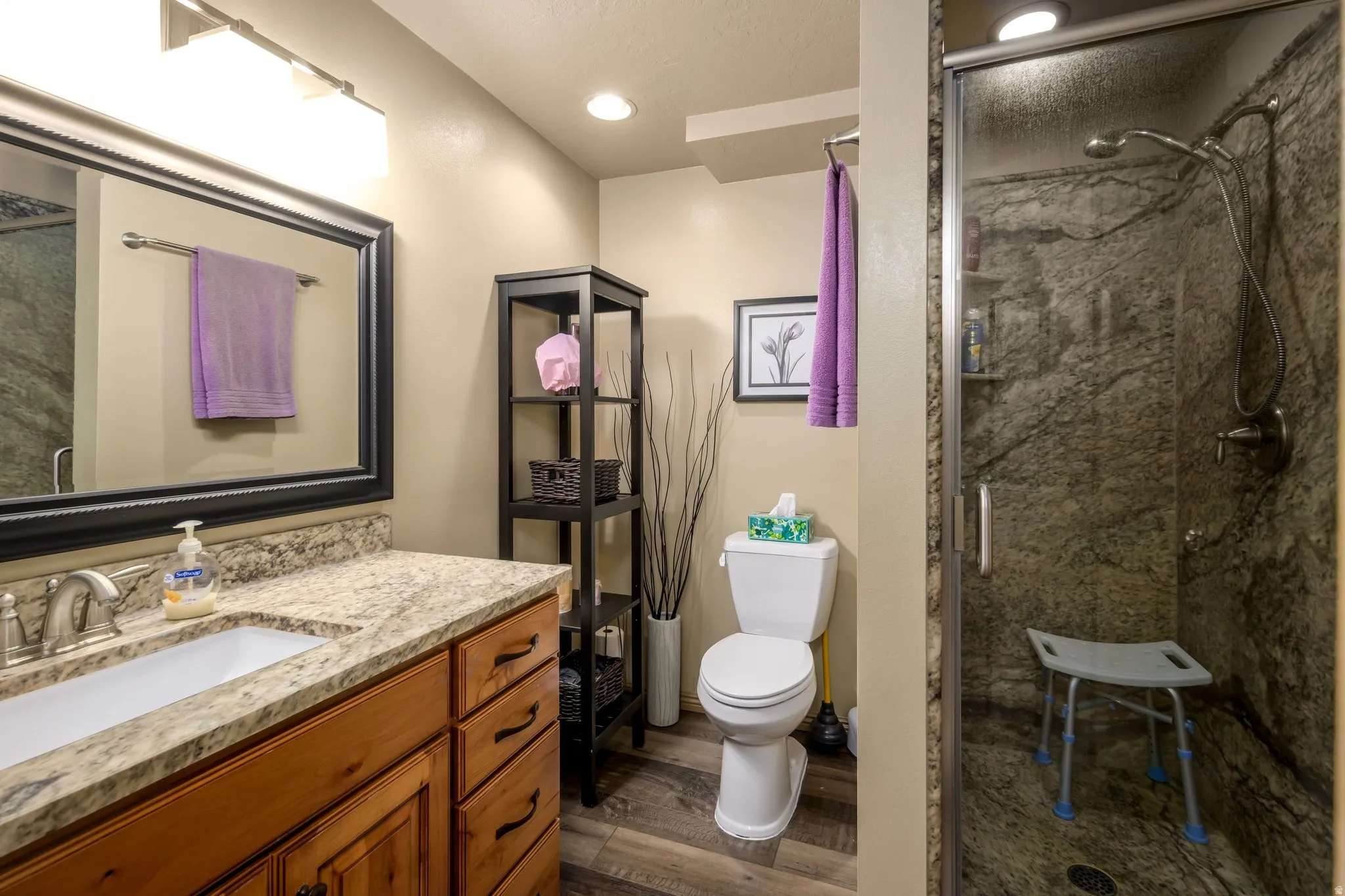 Full bath featuring vanity, a stall shower, and recessed lighting, and wood tiled floors