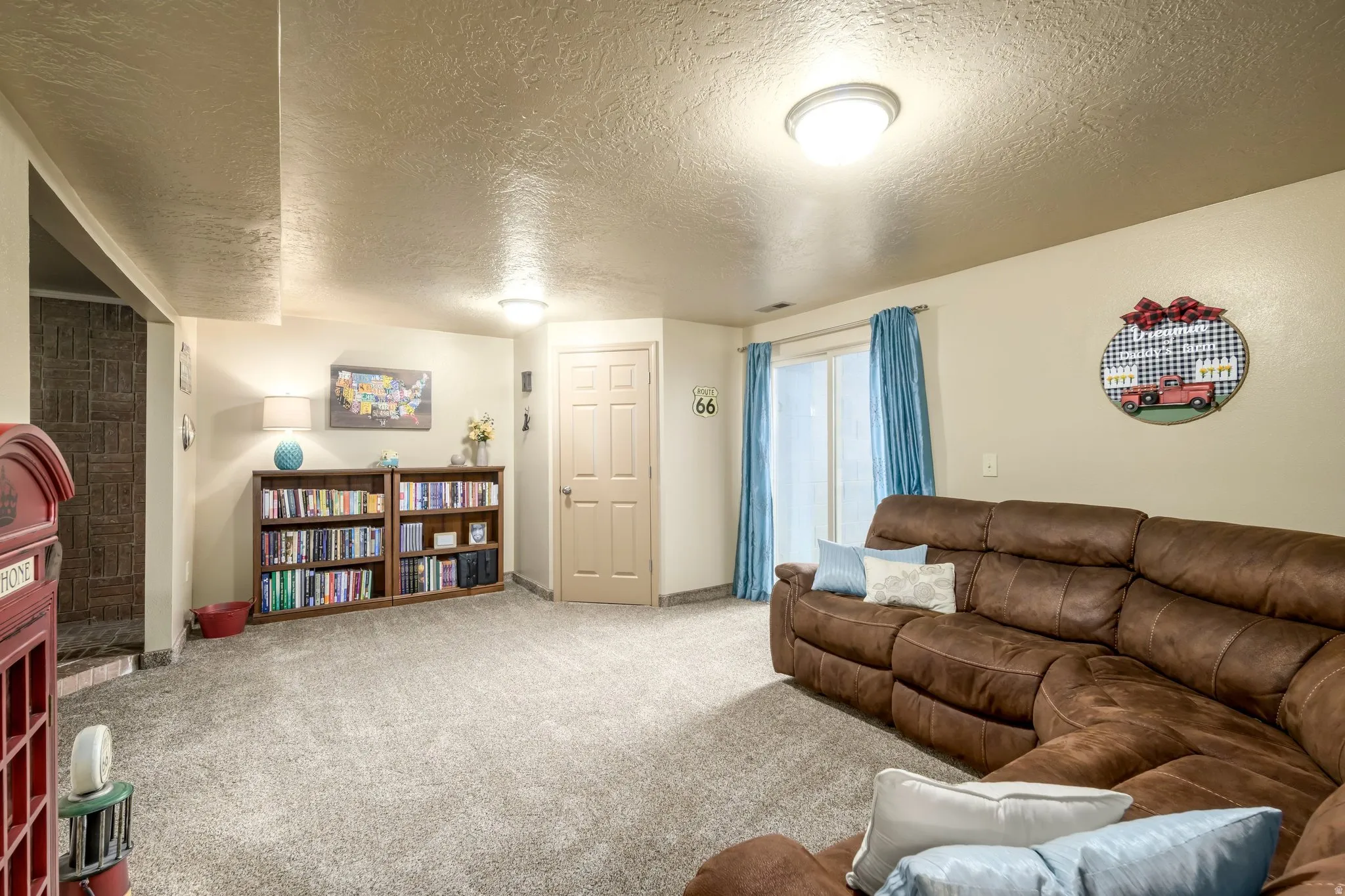 Carpeted living area with a textured ceiling