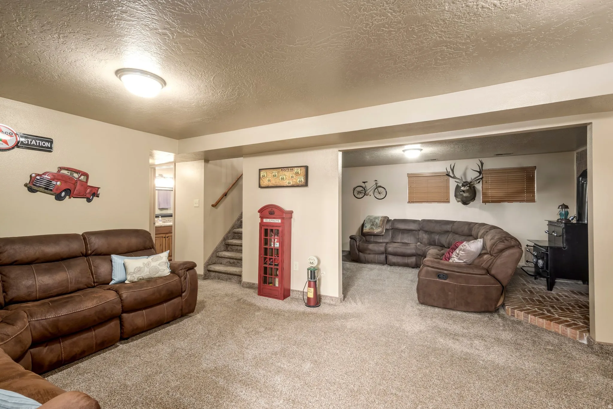 Living area featuring a textured ceiling and carpet flooring