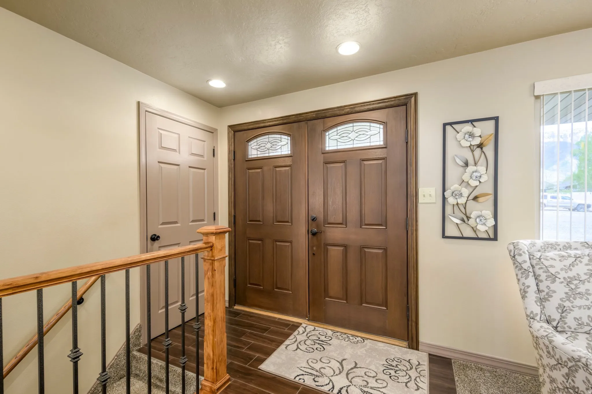 Entryway featuring wood tiled floors, healthy amount of natural light, and recessed lighting