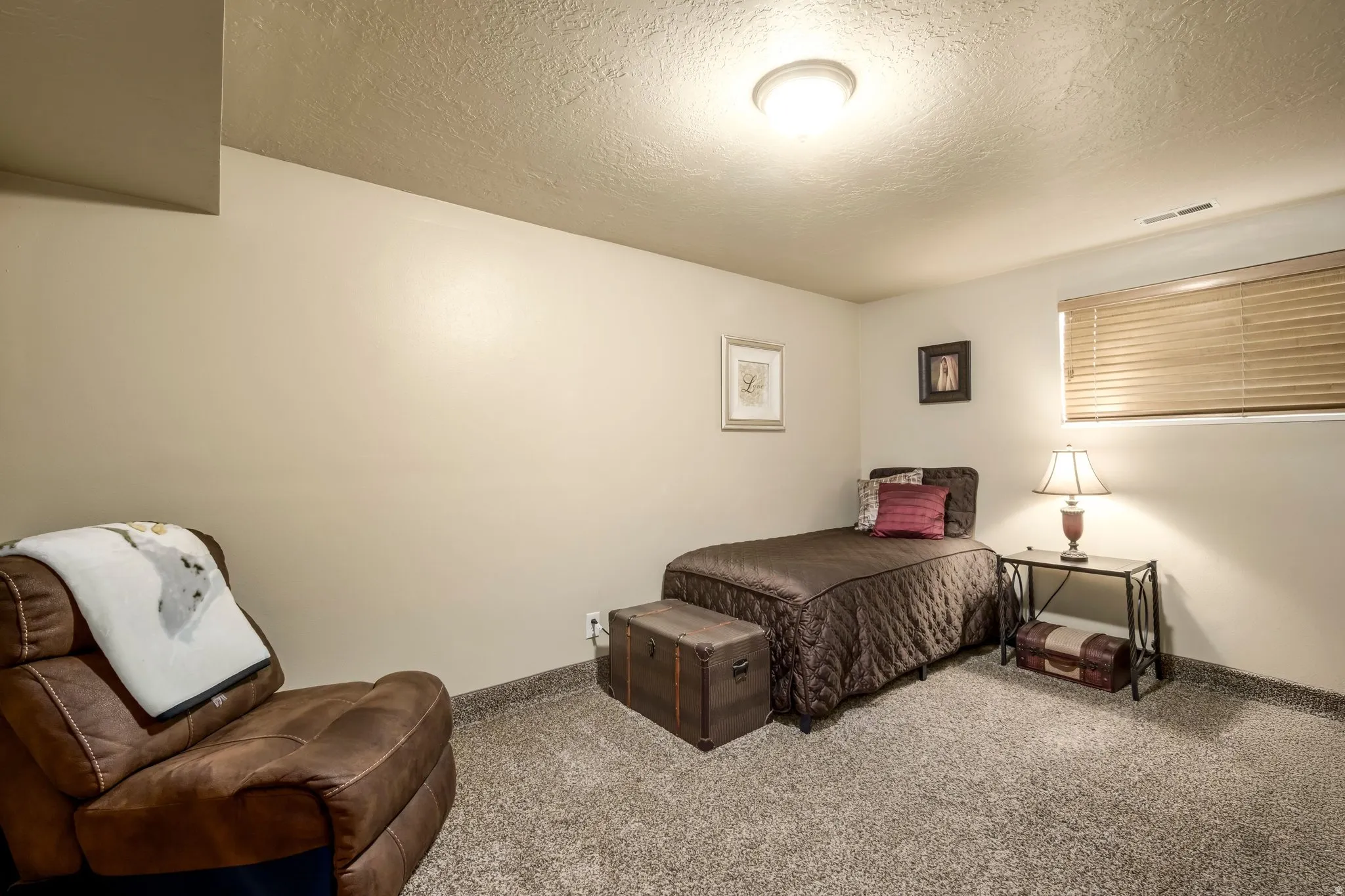 Bedroom with carpet and a textured ceiling