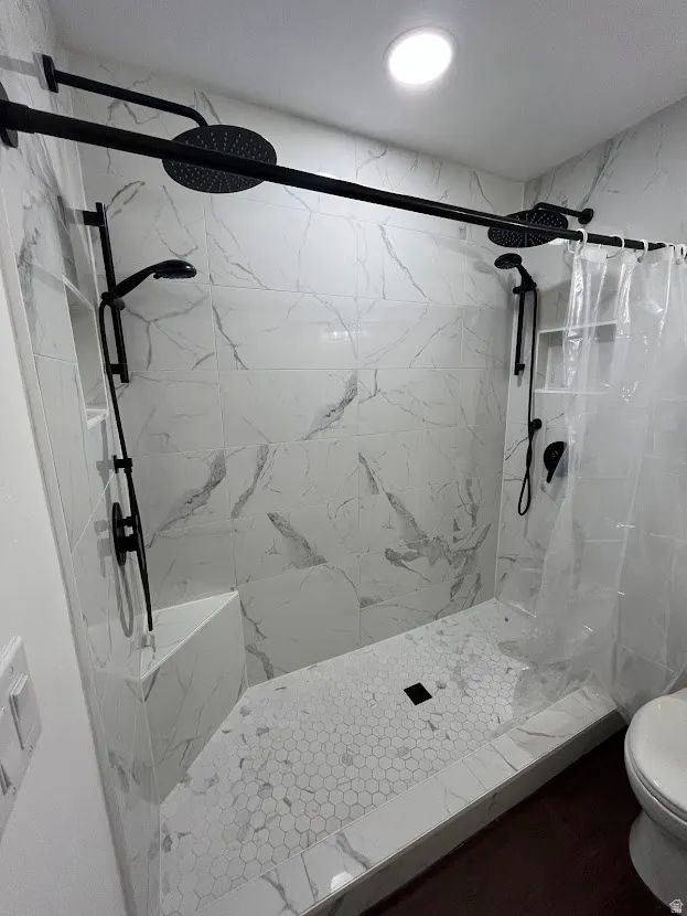 Master bath double headed shower with extra flow water pressure valve. Contemporary tile surround.