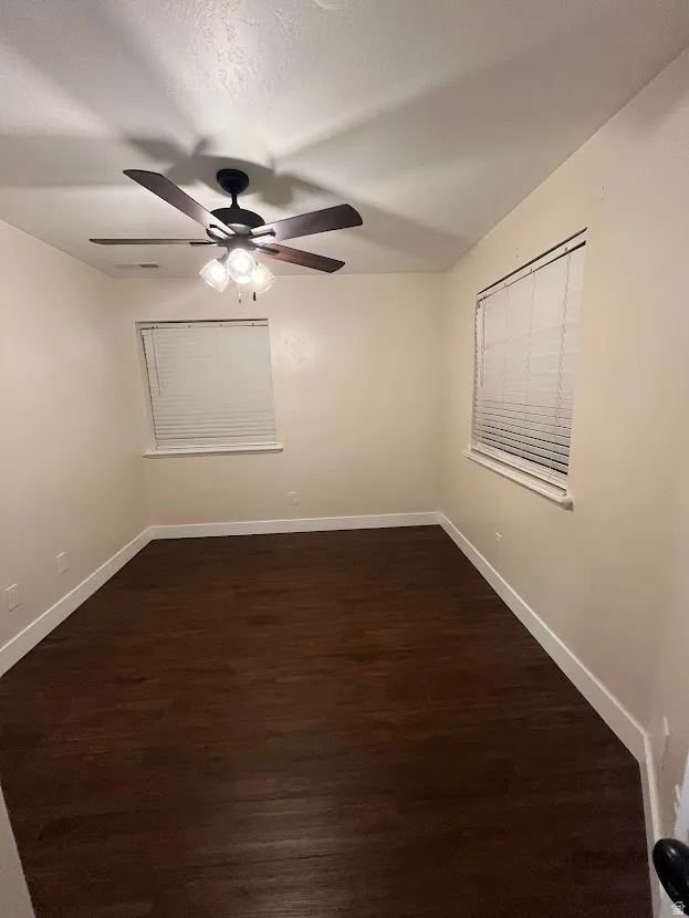 Bedroom 2 with ample light from 2 windows. Ceiling fan.