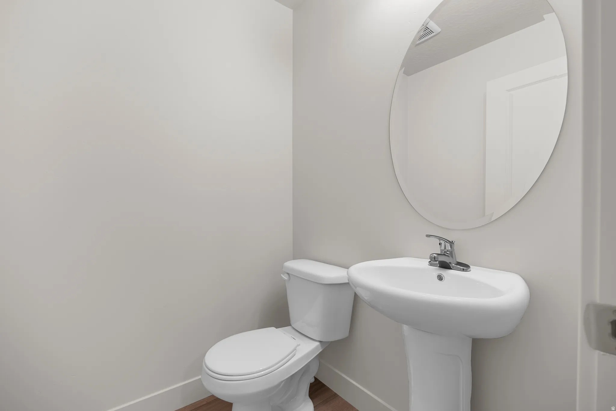 Bathroom featuring toilet and wood finished floors