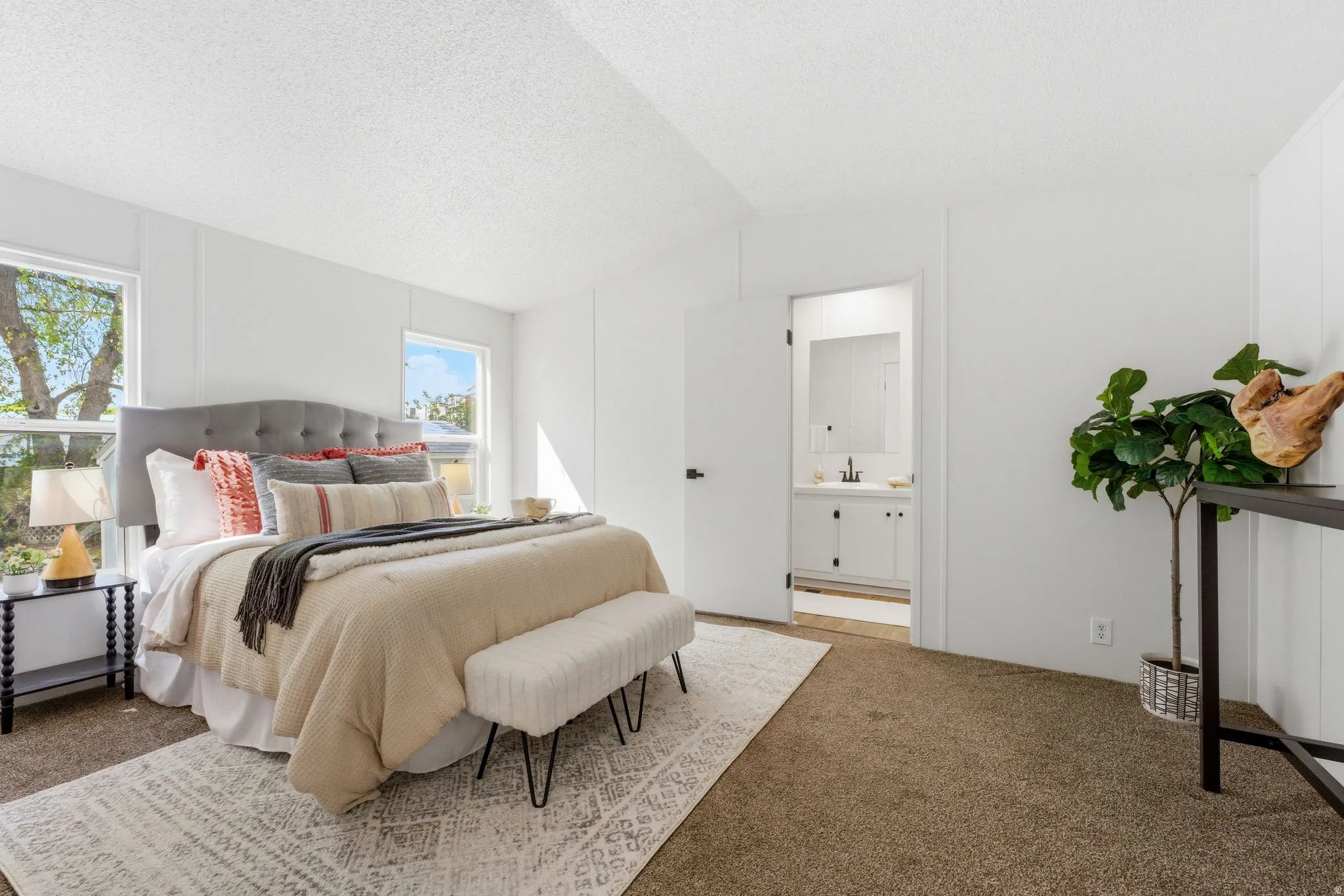 Bedroom featuring carpet floors and ensuite bath