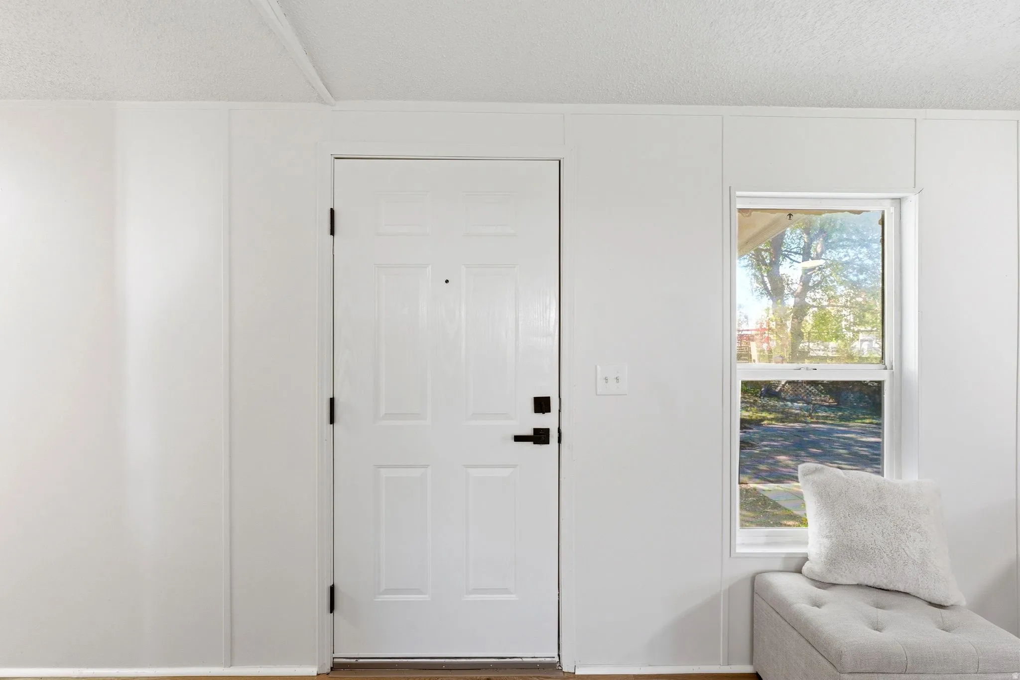 Entrance foyer featuring a textured ceiling and wood finished floors