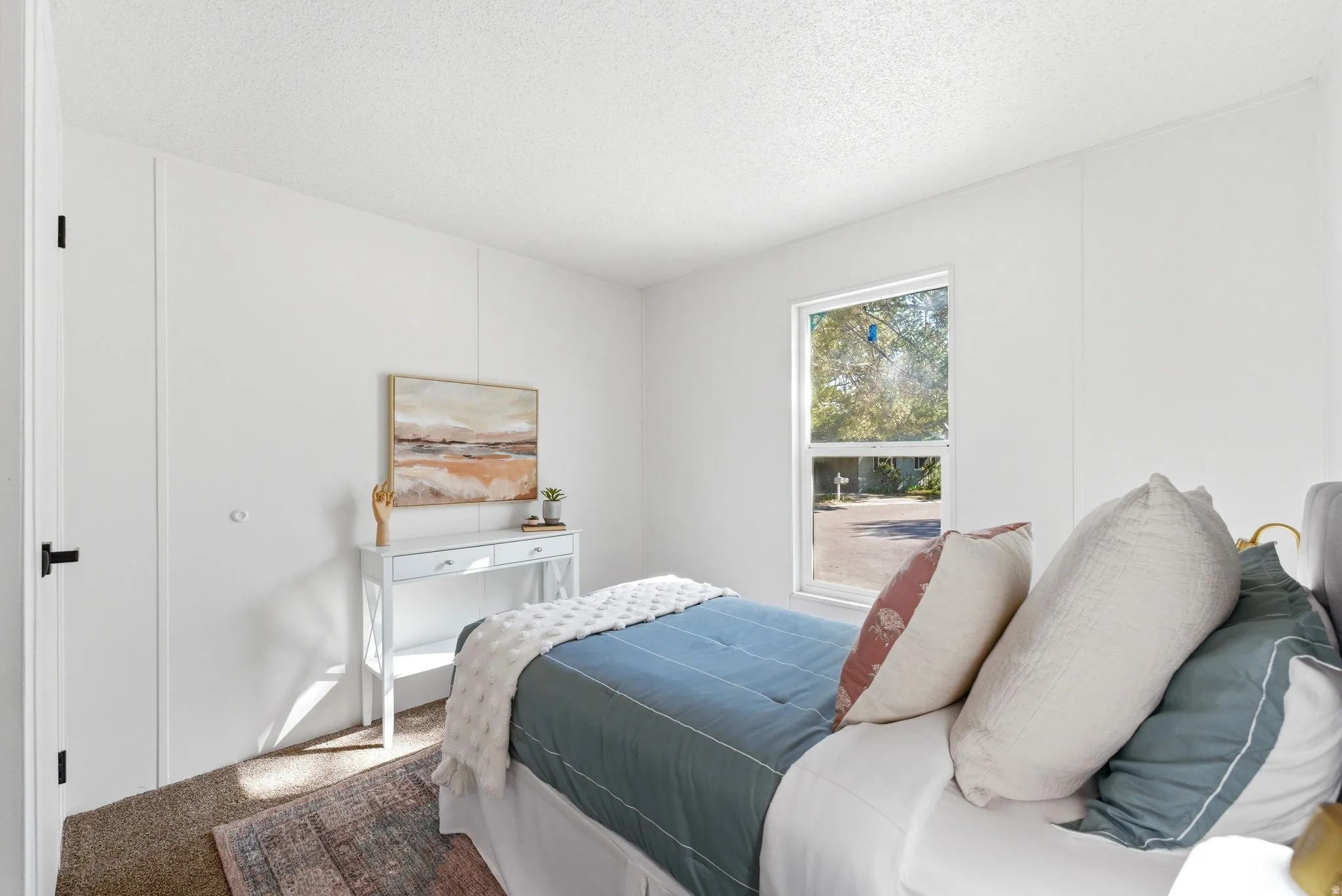 Carpeted bedroom featuring a textured ceiling