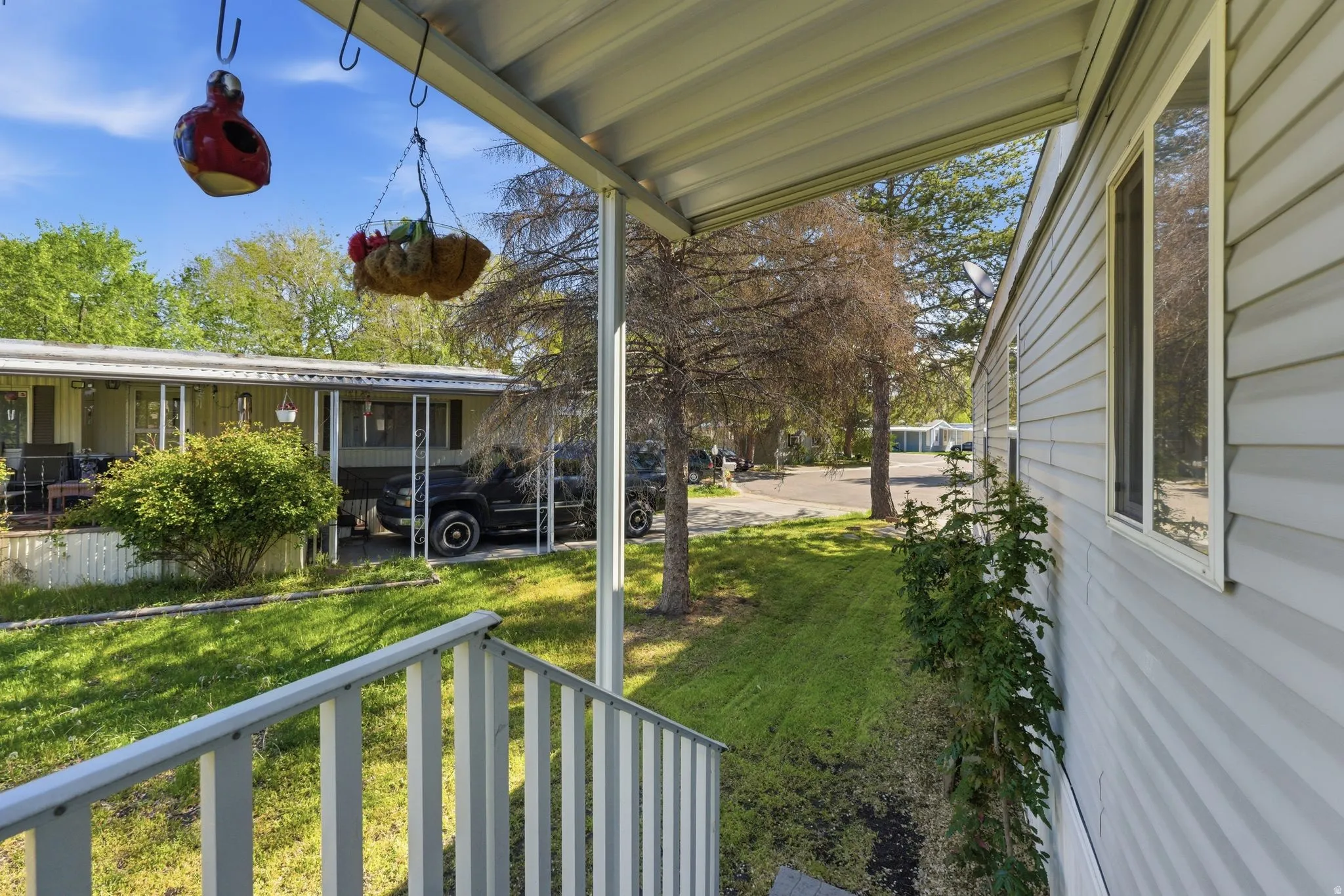 View of grassy yard with a porch