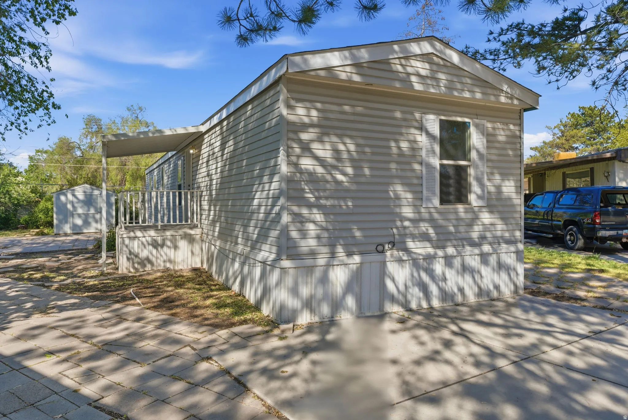 View of side of home featuring an outbuilding