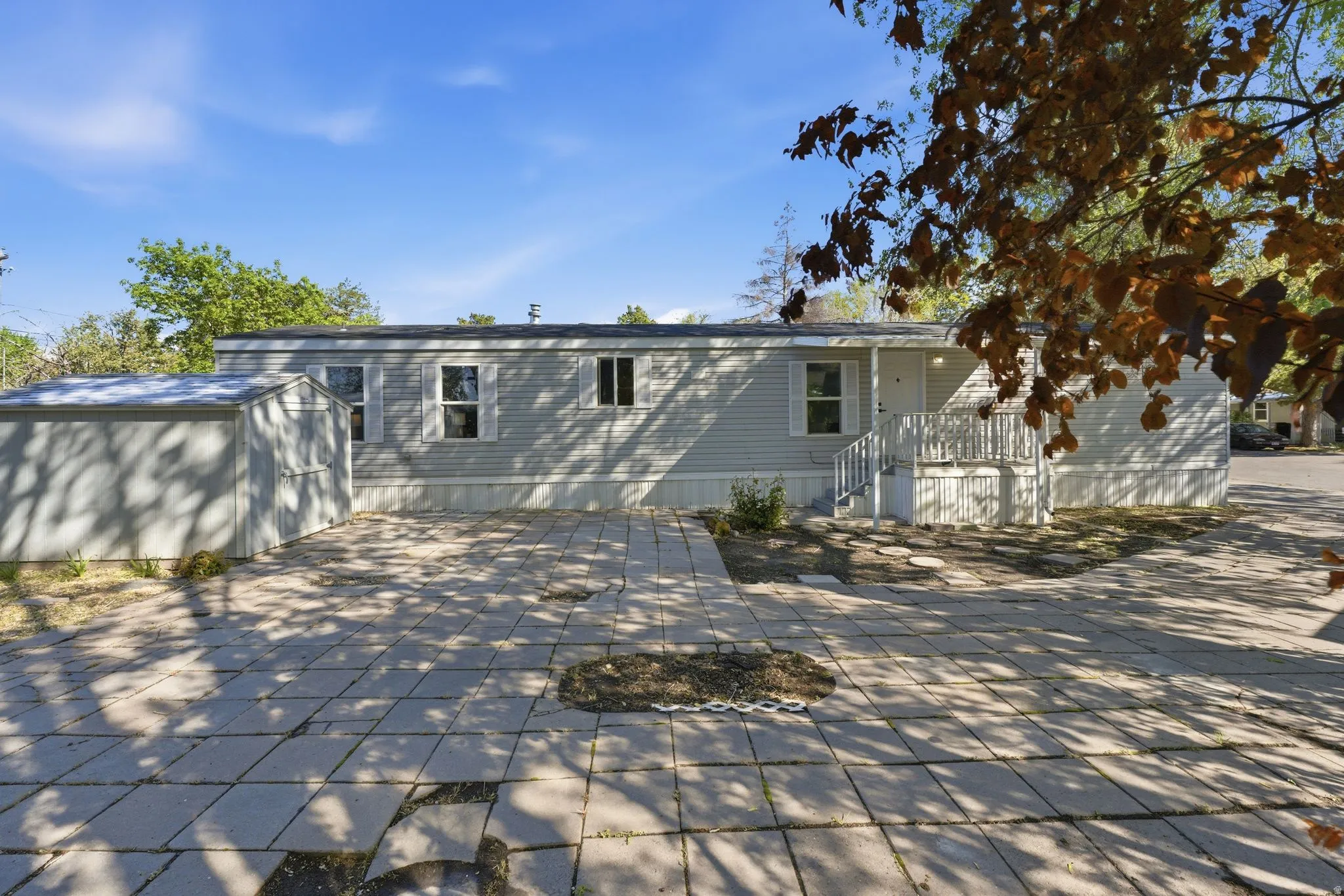Rear view of property with a storage shed