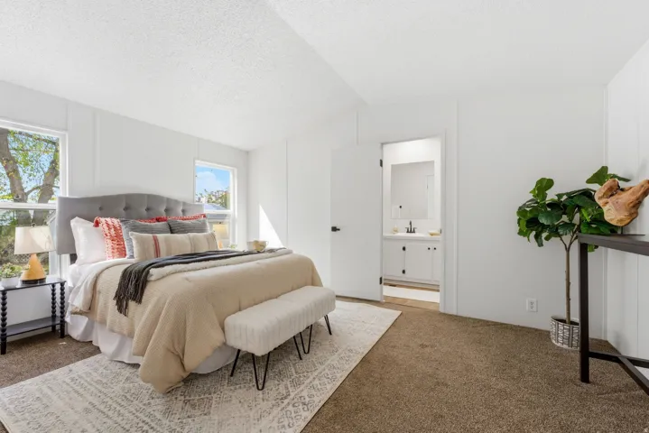 Bedroom featuring carpet floors and ensuite bath