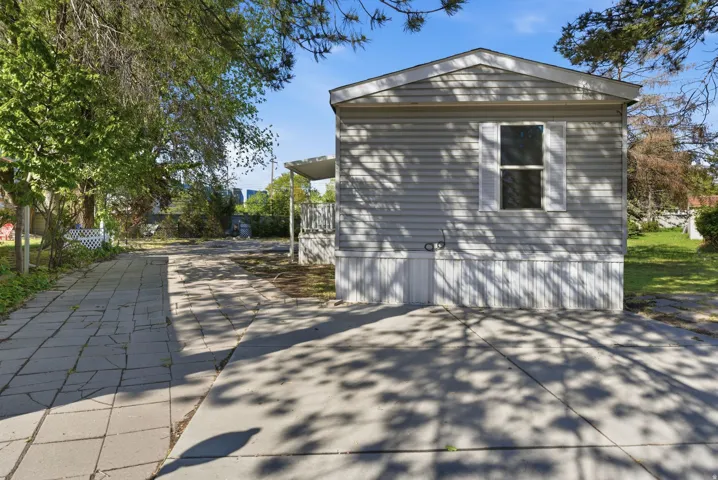 View of side of home with concrete driveway