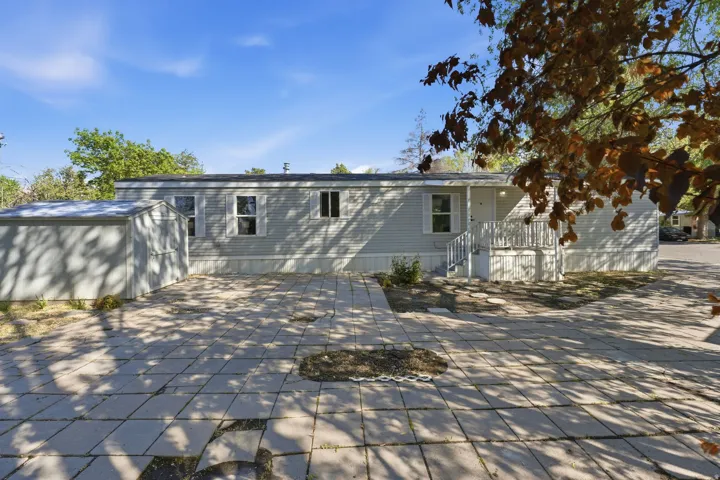 Rear view of property with a storage shed