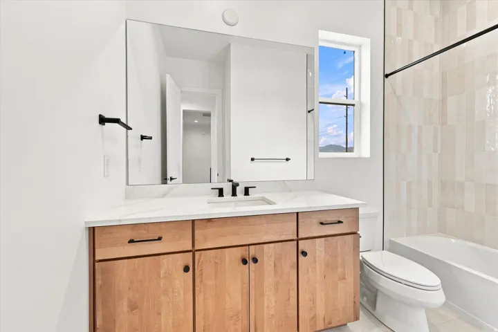 Wood-finish vanity with a white countertop and undermount sink