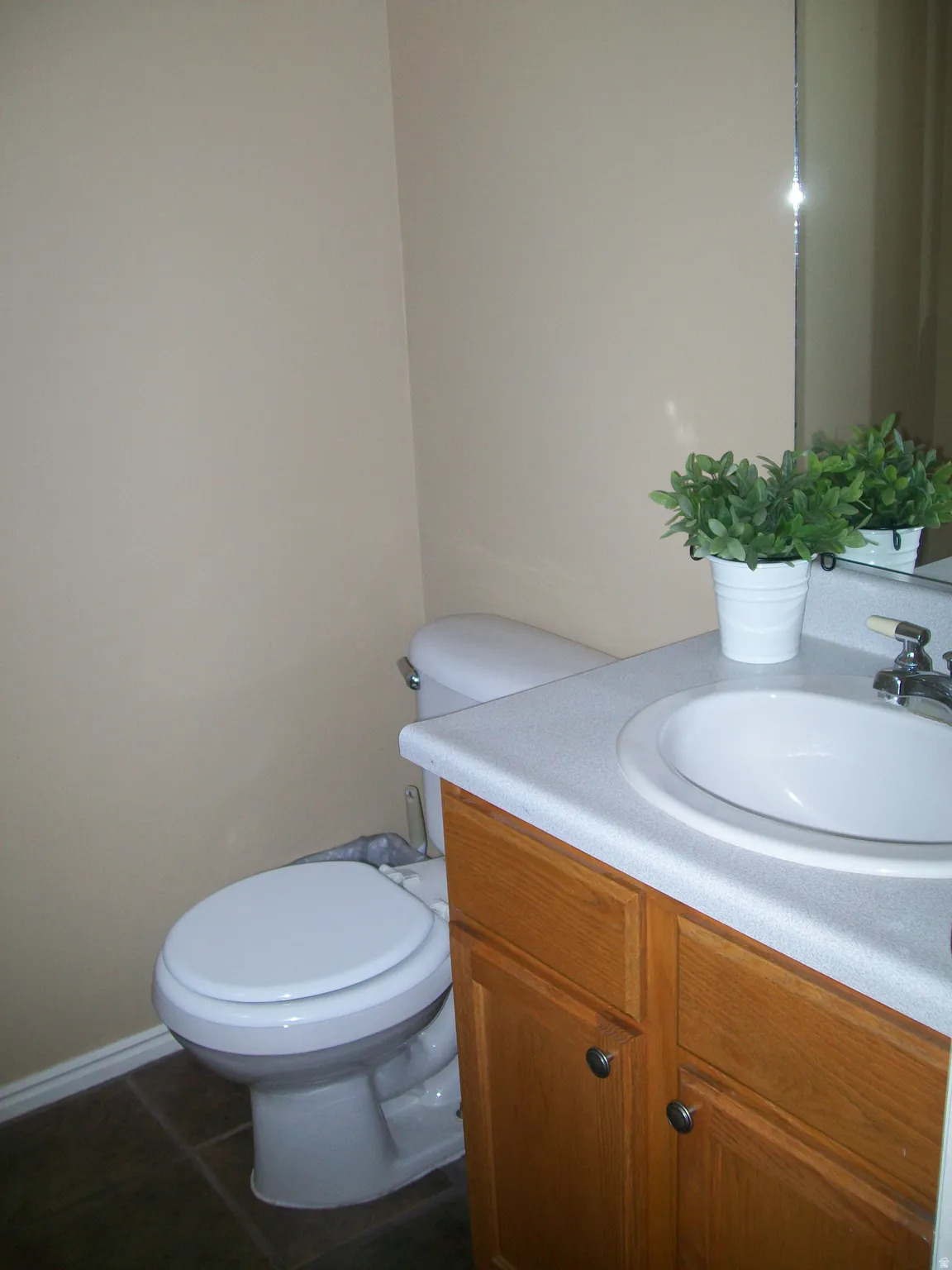 Bathroom featuring vanity and dark tile patterned floors