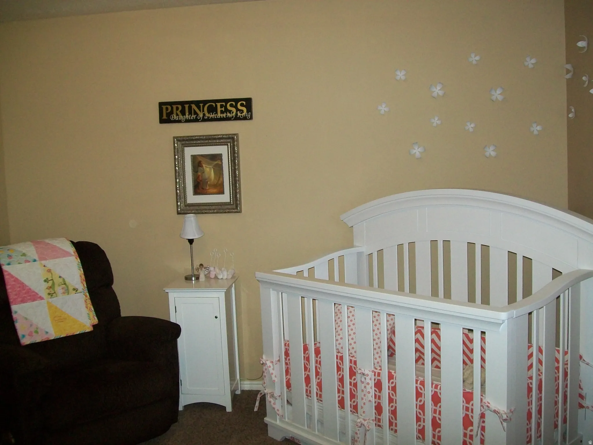 Bedroom featuring dark carpet and a nursery area