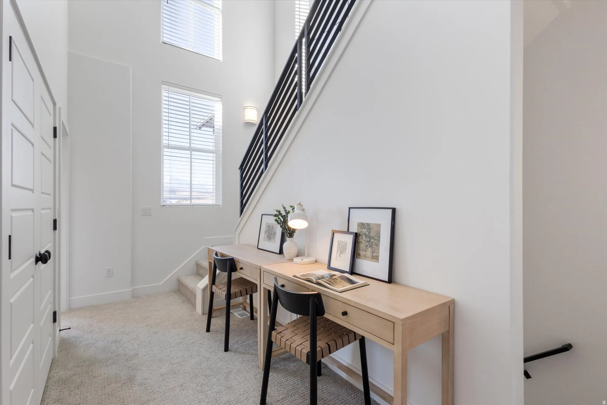 Office area featuring a high ceiling and light carpet