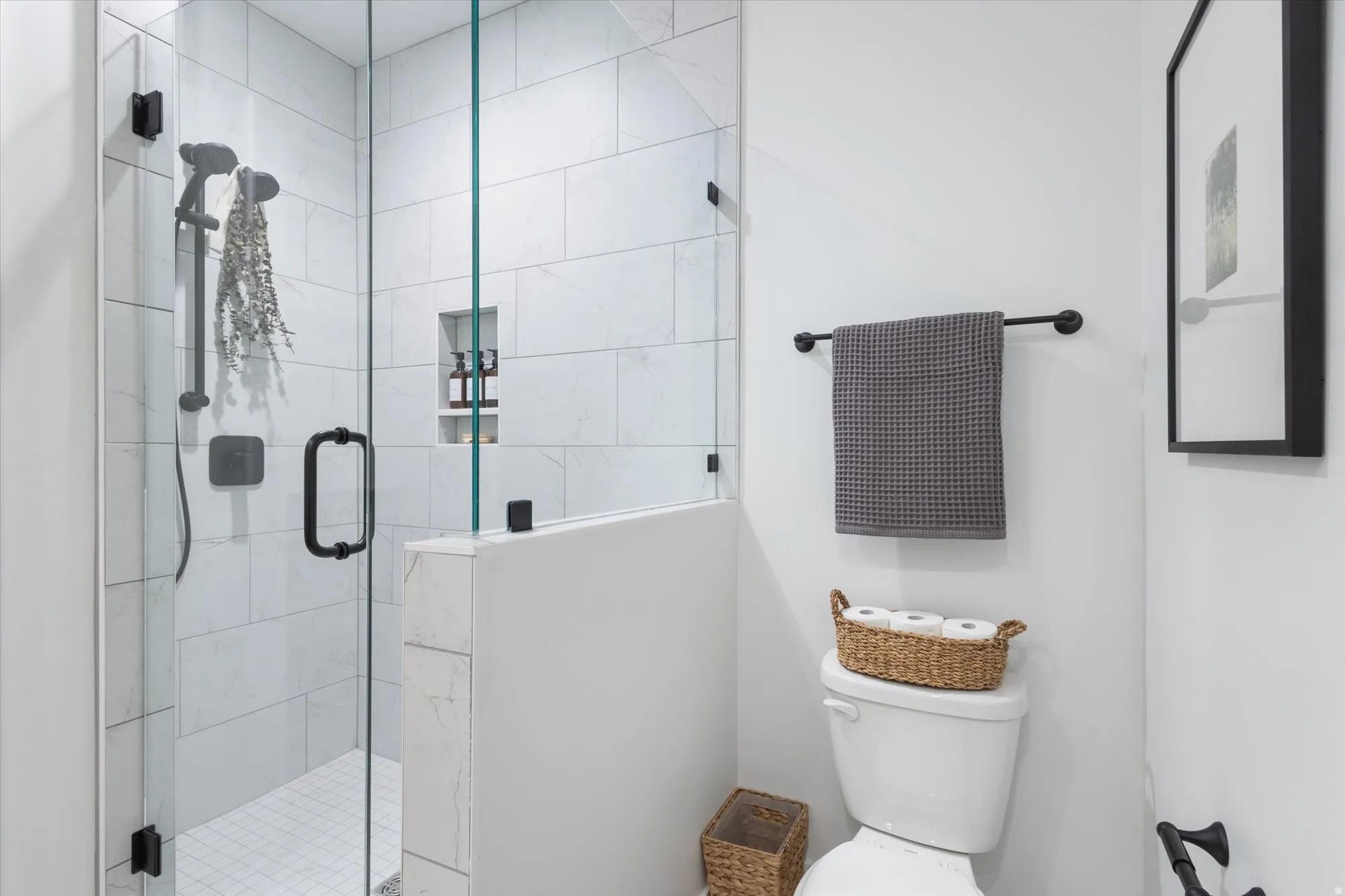 Full bathroom with a stall shower and toilet
