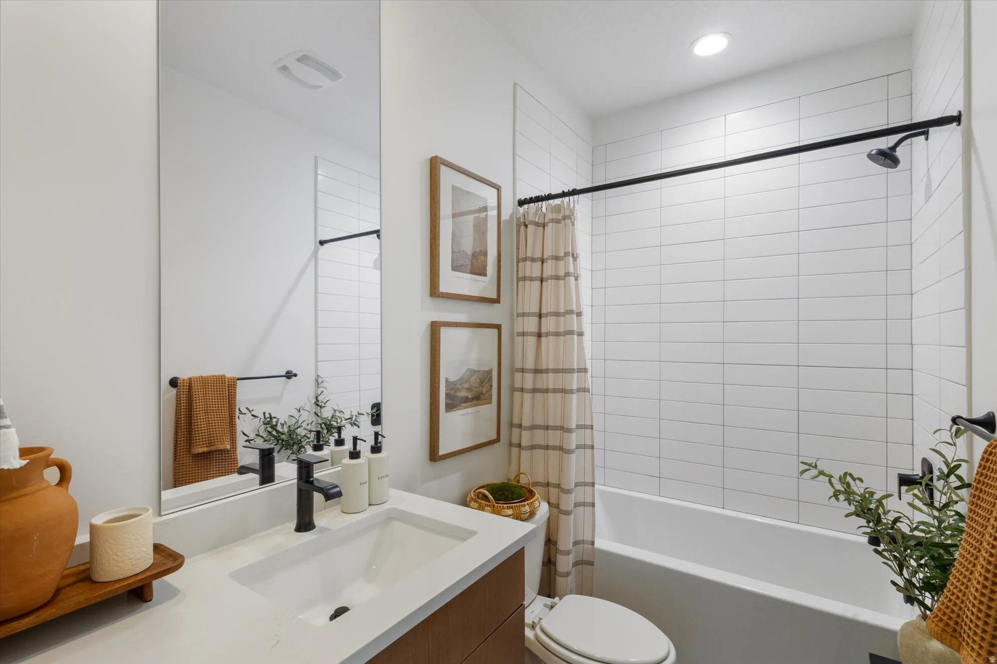 Full bathroom featuring vanity, shower / tub combo with curtain, and recessed lighting