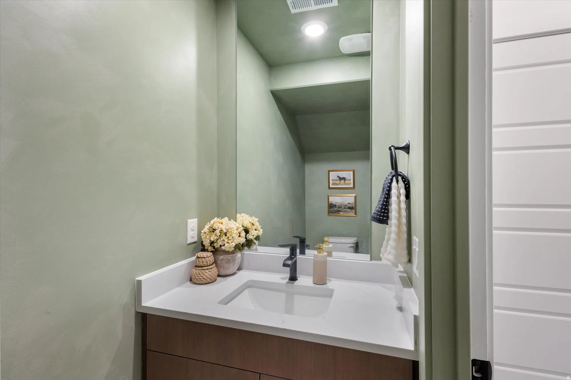 Half bath featuring vanity and toilet