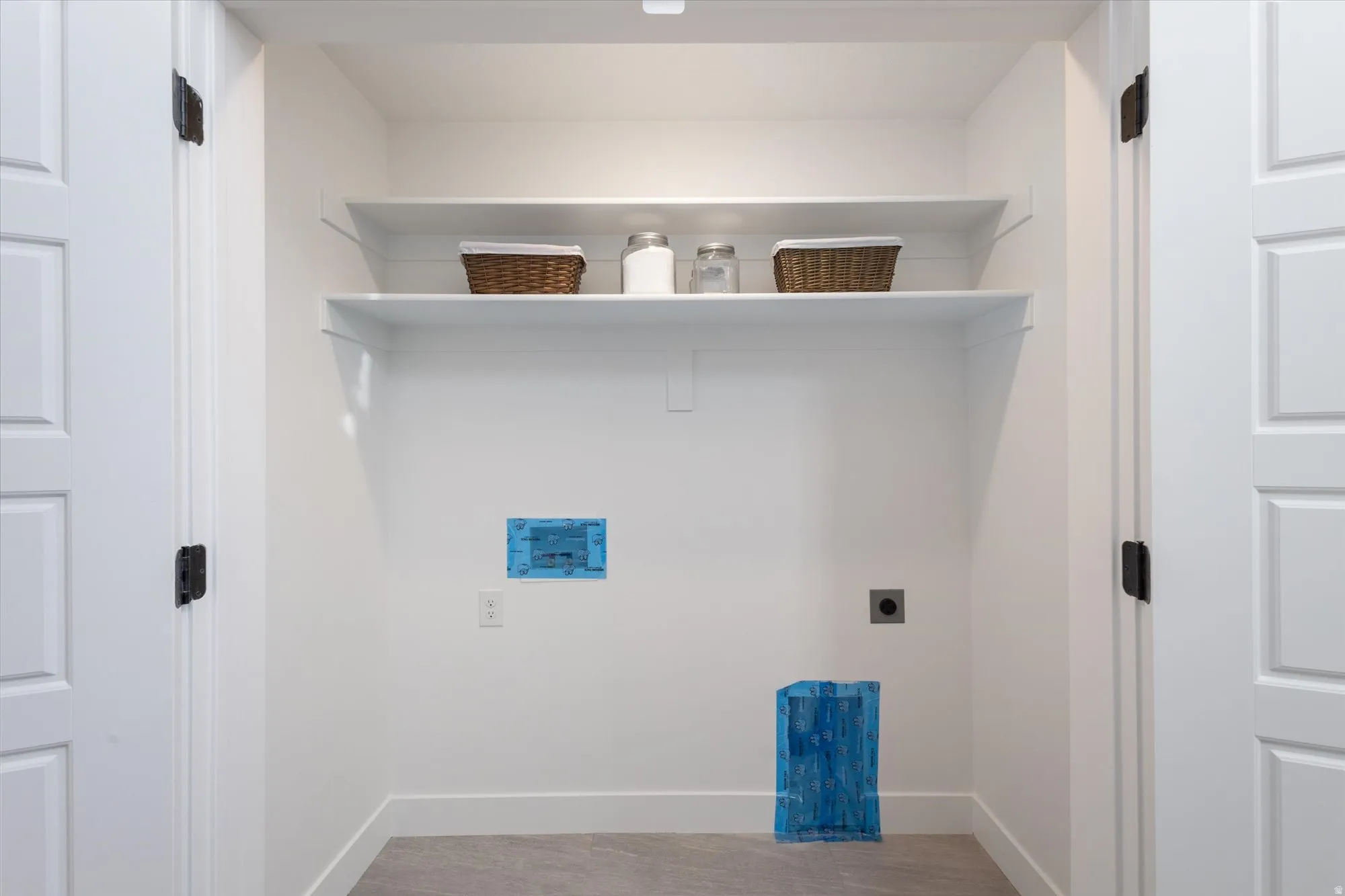 Laundry area featuring hookup for an electric dryer and light wood-style flooring